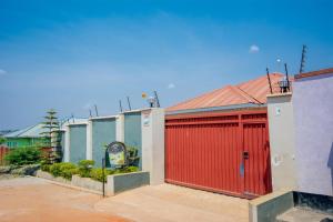 a row of buildings with a red garage at Cherries Egul Lodges in Lilongwe