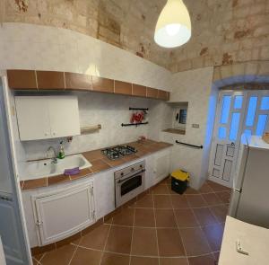 a kitchen with a sink and a stove top oven at trulli Annina in Locorotondo