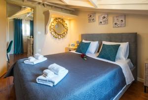 a bedroom with a blue bed with towels on it at Star Jasmine House Acharavi in (( Litherés ))