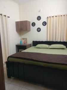 a bedroom with a large bed with at SindooRa in Mysore