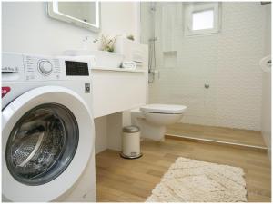 a bathroom with a washing machine and a toilet at MARI in Dolac +28 photos