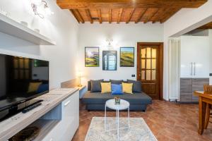 - un salon avec un canapé et une table dans l'établissement Homiday - Tuscany House - Parcheggio e Giardino Privato, à Pise
