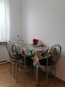 a table with chairs with a colorful table cloth on it at Centrum One in Suwałki
