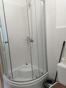 a shower with a glass door in a bathroom at Centrum One in Suwałki