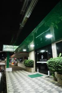 a building with a sign on the side of it at Frota Palace Hotel in Macapá