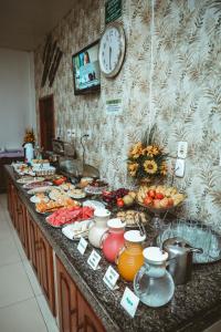 a buffet of food on a counter in a kitchen at Frota Palace Hotel in Macapá