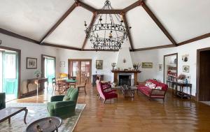 a large living room with a chandelier and a fireplace at Casa da Agrela in Ponte da Barca