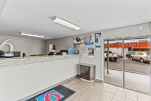 a lobby with a bar and a parking lot at Studio 6 Wilmington, NC in Wilmington