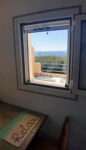 a window in a room with a view of the ocean at Il Veliero in Fiskardo