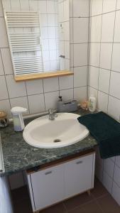 a bathroom counter with a sink and a mirror at BBBB Resort Apartman Zalakaros in Zalakaros