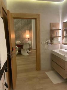a bathroom with a sink and a table with chairs at Anfa Place, Luxury Apartment just renovated, Ocean View in Casablanca
