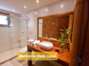 a bathroom with a sink and a toilet at Aldeia do Bambu Camping e Chalés in Quartéis +104 photos
