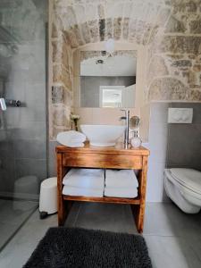 a bathroom with a sink and a shower and a toilet at Guest House Kala in Split