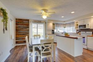 a kitchen with a table and a ceiling fan at Coudersport Home with Outdoor Spa and Stargazing! in Coudersport
