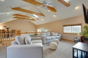 a living room with white furniture and a ceiling fan at Coudersport Home with Outdoor Spa and Stargazing! in Coudersport
