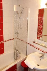 a bathroom with a shower and a sink and a tub at Kyriad Hotel XIII Italie Gobelins in Paris