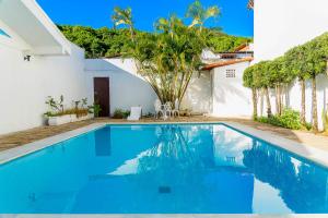 a swimming pool in the backyard of a house at GB Hoteis Natal in Natal