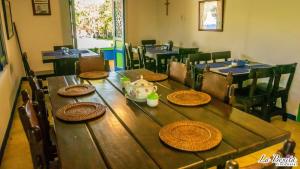a wooden table with plates on top of it at FINCA HOTEL LA BONITA BY LA MACORINA in Quimbaya