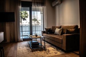 a living room with a couch and a table at Apartman SoHo 2 in Trebinje