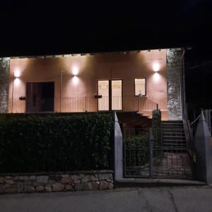 a house with lights on the side of it at night at Il Sole di Simona - Il Prato in Omegna