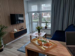 a living room with a table with a tray of food on it at Apartament Happy Stay in Rzeszów