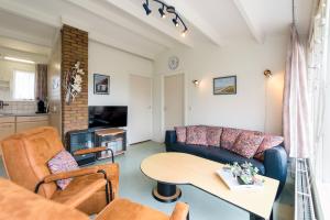 a living room with a couch and a table at Quisisana in Buren