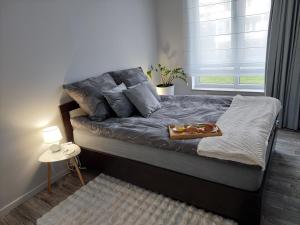 a bedroom with a bed with a tray of donuts on it at Apartament Happy Stay in Rzeszów