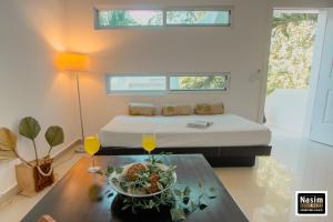 Habitación con cama y mesa con plato de comida en Nasim Condo Hotel con acceso BEACH CLUB GRATIS, metros 5th AVENIDA, en Playa del Carmen
