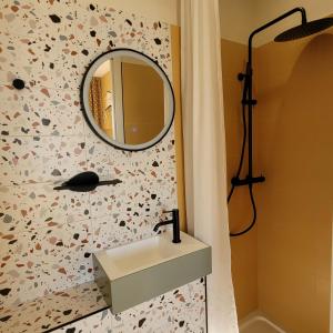 a bathroom with a sink and a mirror on the wall at Seakub hotel in Royan