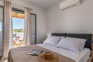 a bedroom with a bed with a view of the ocean at Casa Aelia ,Stelida Naxos in Stelida