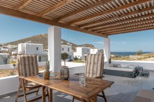 a wooden table and chairs on a patio with a view at Casa Aelia ,Stelida Naxos in Stelida