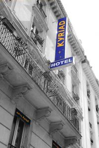 a street sign in front of a building at Kyriad Hotel XIII Italie Gobelins in Paris