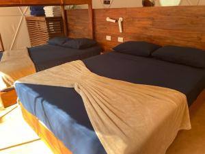 two beds sitting in a room with at Ku kuk Glamping in Chemuyil