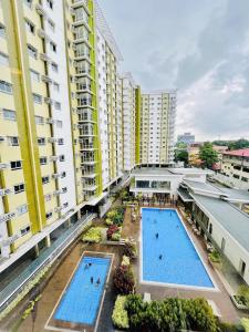 an overhead view of two swimming pools in a building at Spacious Combine Family Unit Condo at Mesaverte Residences downtown near SM Gaisano Robinson and Centrio in Cagayan de Oro