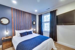a bedroom with a large bed and a large television at Pet-Friendly Basye Vacation Rental with Fireplace! in Basye