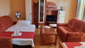 a living room with two beds and a couch at Lucy in Podstrana