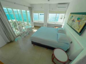 a bedroom with a bed and a view of the ocean at Condo in Puerto las Hadas in Manzanillo +45 photos