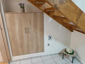 a wooden cabinet in the corner of a room at Two-storey maisonette next to the port in Mantoúkion