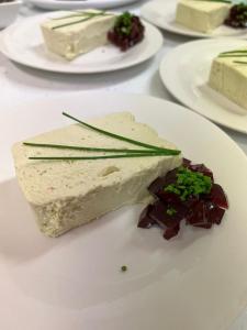 a white plate with a piece of food on a table at Bryn Noddfa in Morfa Nefyn