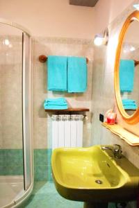 a bathroom with a green sink and a shower at Cozy apartment in Prabione, 30 m², charming balcony in Campione del Garda