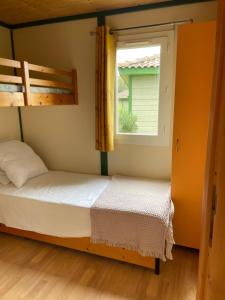 a bedroom with two bunk beds and a window at Lavallee in Campomoro