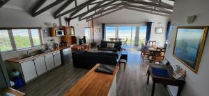 a living room with a couch and a table at Baywatch Paternoster - The Penthouse in Paternoster
