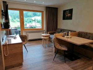 a living room with a table and a couch at Pension Sohlhof in Baiersbronn