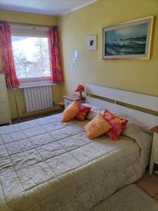 a bedroom with a large bed with pillows on it at Cervinia Apartments in Breuil-Cervinia