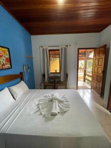 a bedroom with a bed with a towel on it at Pousada Licuri in Serra do Cipo +37 photos