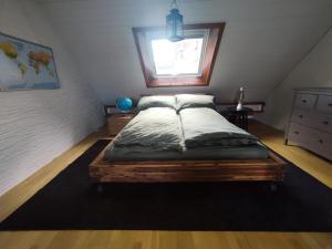 a bedroom with a large bed in a attic at Central-city Penthouse in Bern