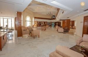 a lobby of a hotel with tables and chairs at Telemaque Beach & Spa - All Inclusive - Families and Couples Only in Houmt Souk
