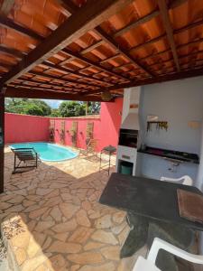 a patio with a table and a swimming pool at Pousada Licuri in Serra do Cipo