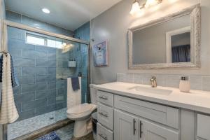 a bathroom with a sink and a toilet and a mirror at Captivating 3 Bedroom Home W Hot Tub in Citrus Heights