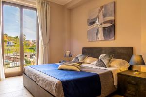 a bedroom with a bed and a large window at Villetta Desiderio Apartment in Giardini Naxos